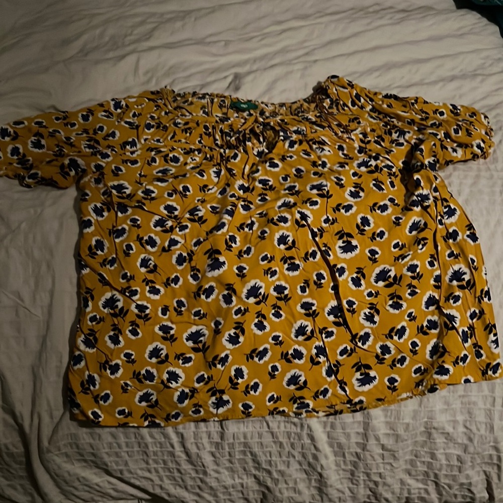 Yellow with blue flowers, have longer sleeves, a tie in the front size xl, dip